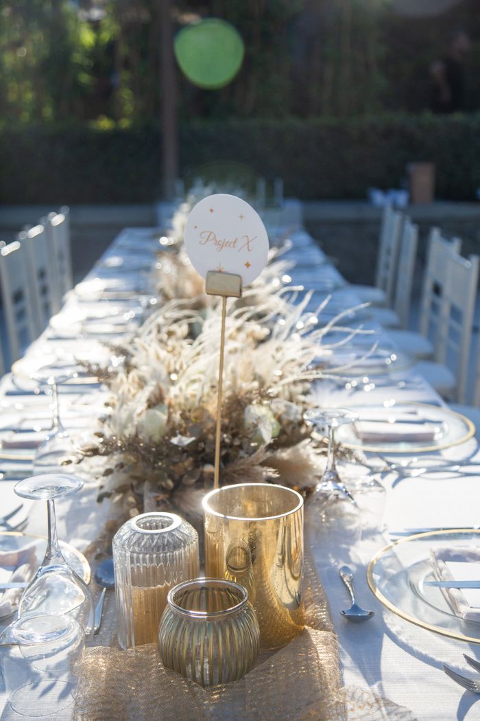 Decorative table setting for a summer wedding outdoors with elegant glassware and centerpieces.